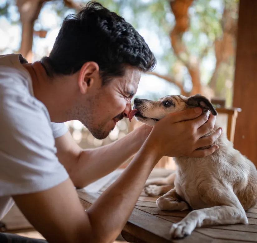 man kissing dog